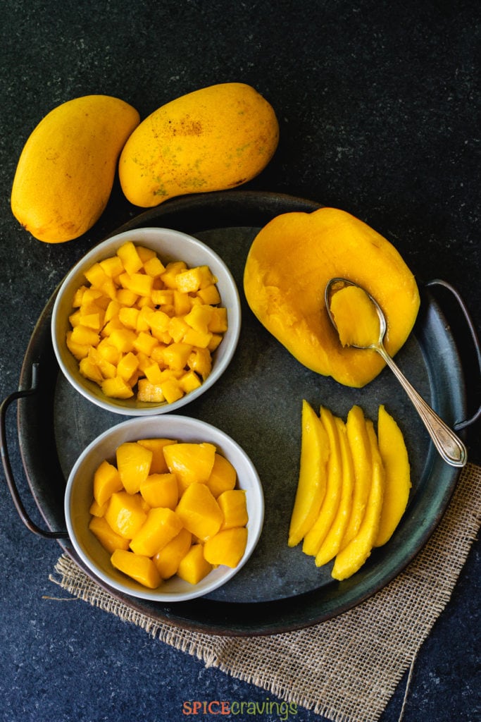 mango sliced, cubed, diced and scooped with a spoon