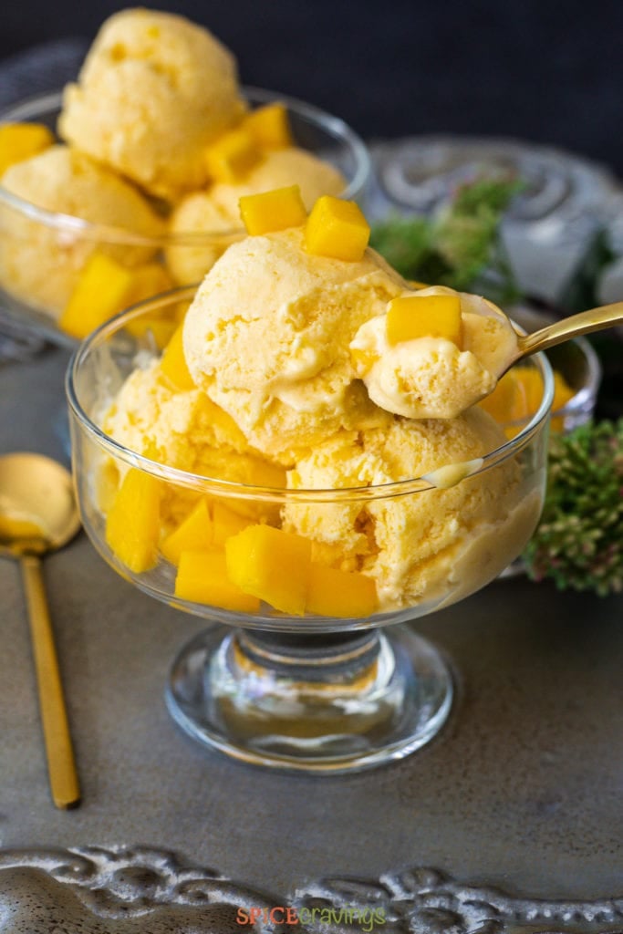 mango ice cream being scooped with spoon