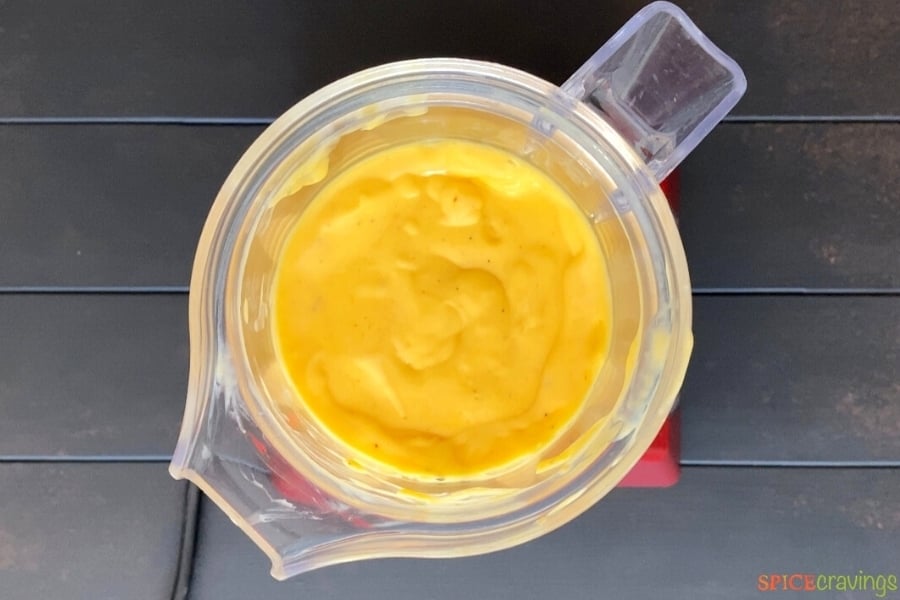 Pureed mango lassi in blender jar