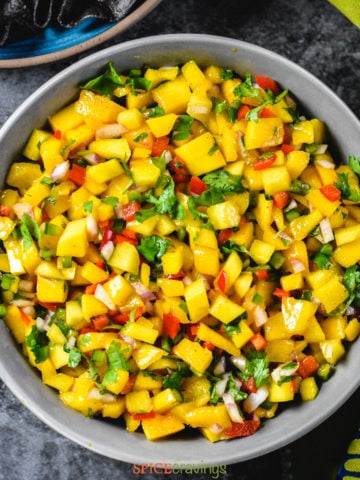 Bowl of mango salsa with mango, peppers and cilantro