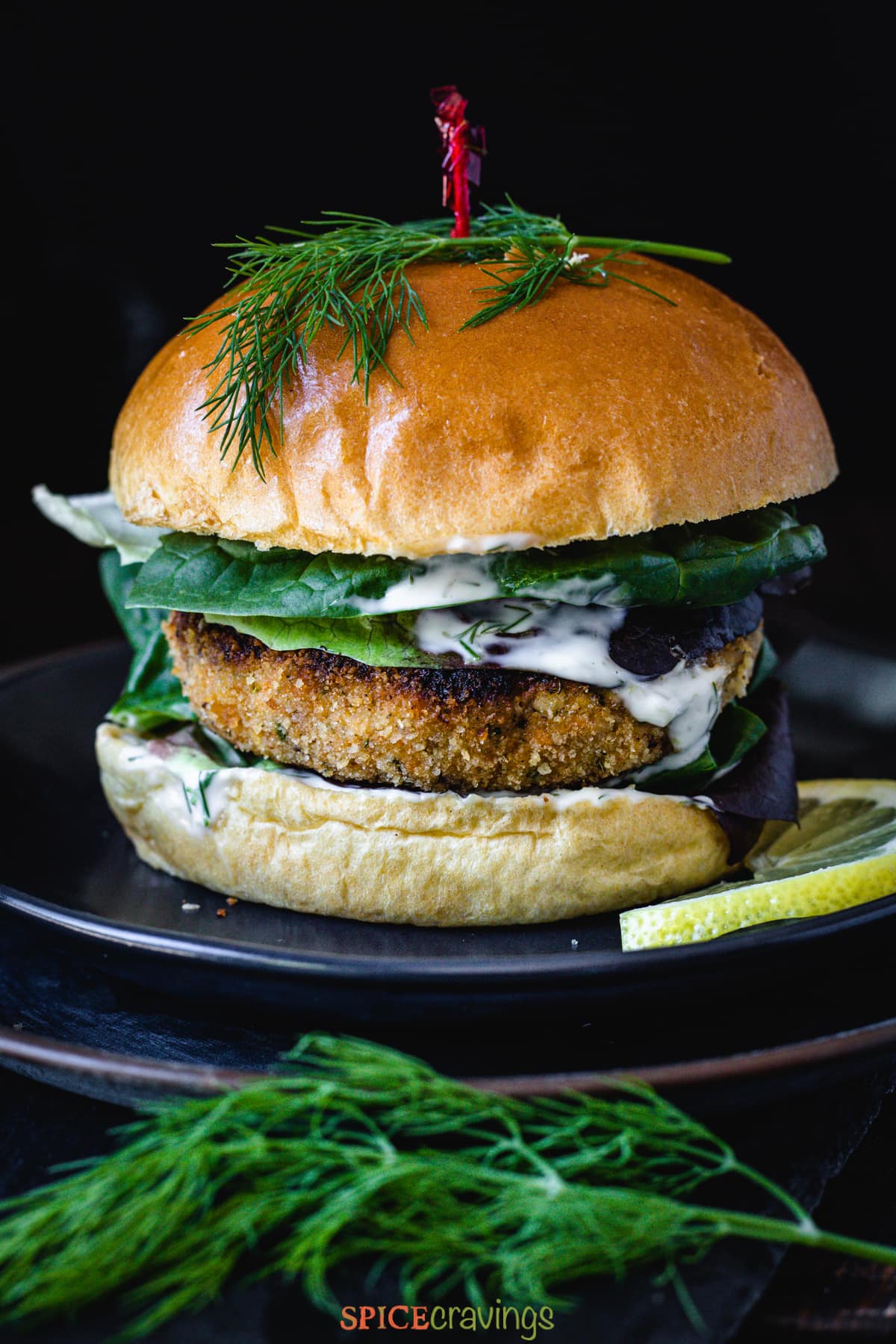 Salmon burger with spinach, dill and lemon caper sauce in the burger