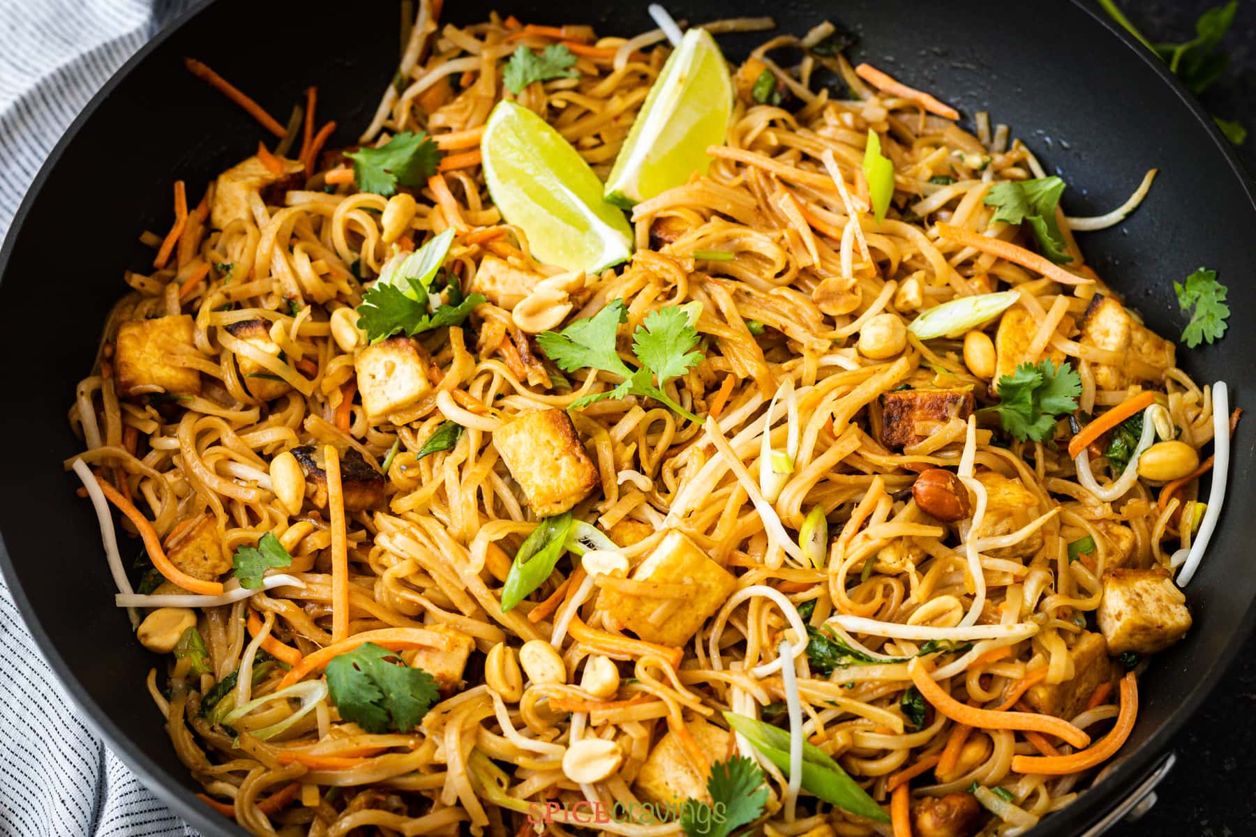 pad thai with noodles and tofu in wok
