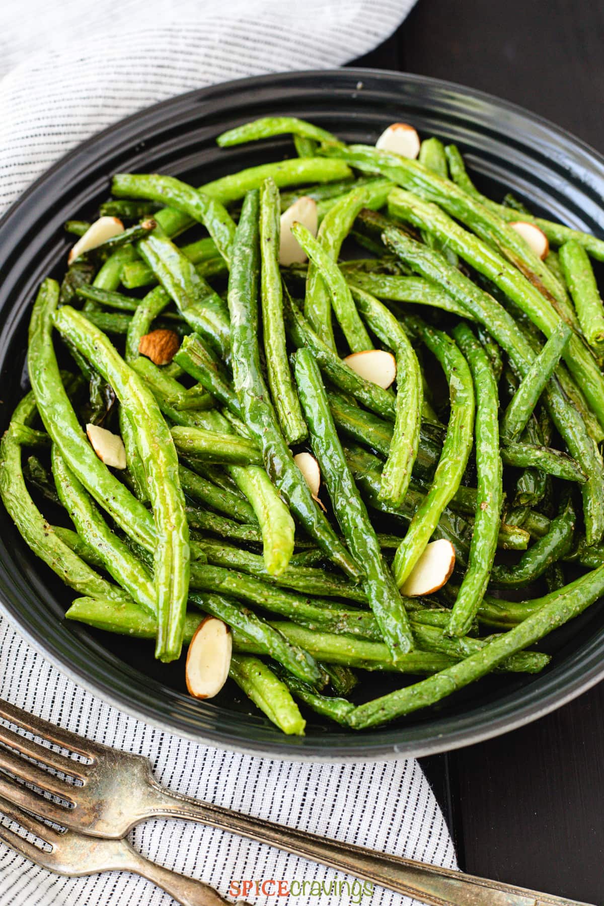 plate of air fryer green beans garnished with almond chips