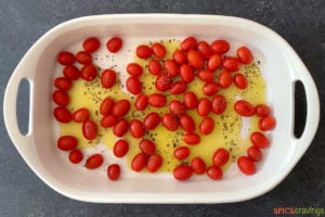 tomatoes and olive oil in baking dish