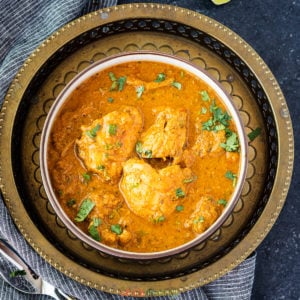 easy south indian chicken chettinad in bowl on metal plate