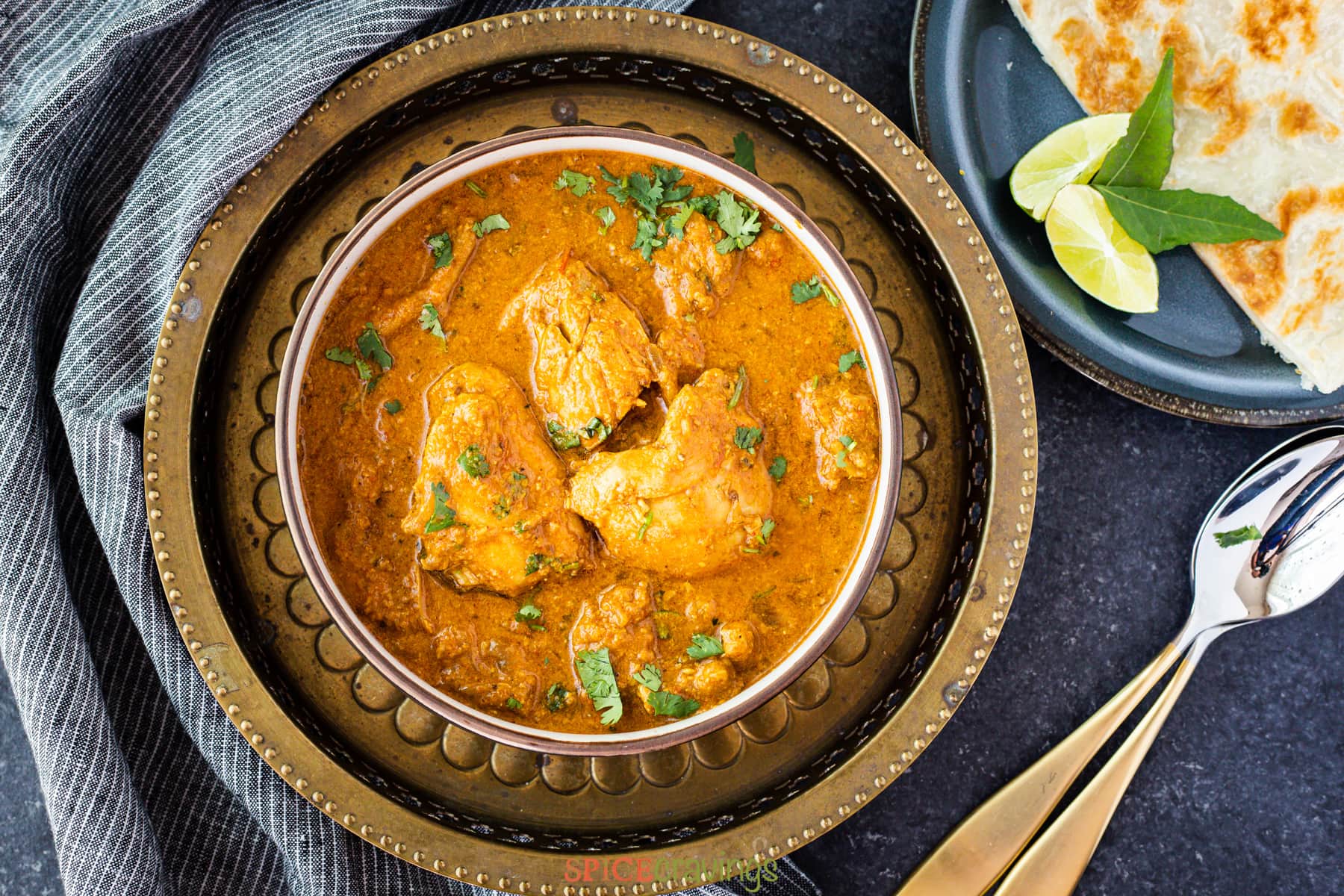 chicken curry in bowl on metal plate