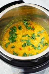 Cooked yellow lentils in instant pot garnished with cilantro