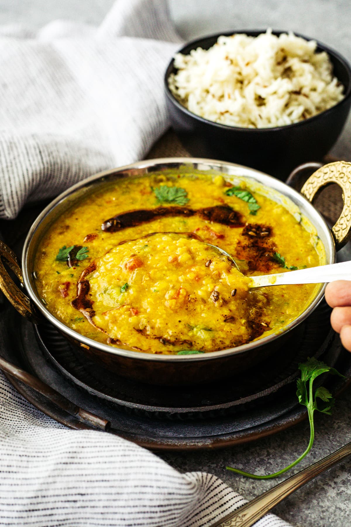 moong dal in pot with bowl of rice in the background