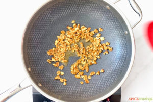 walnuts being toasted in skillet