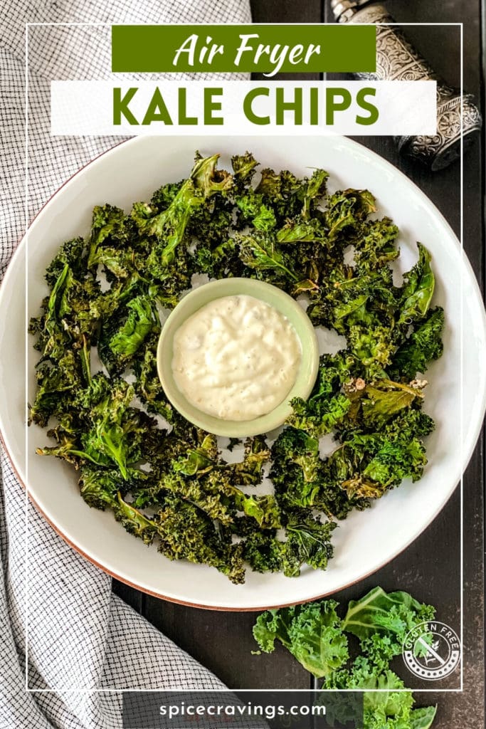 White bowl with kale chips and dip in center