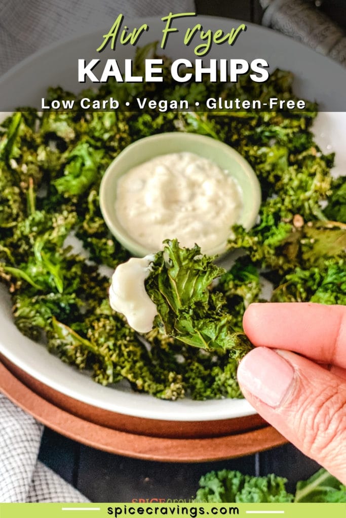 Hand holding kale chips with dip