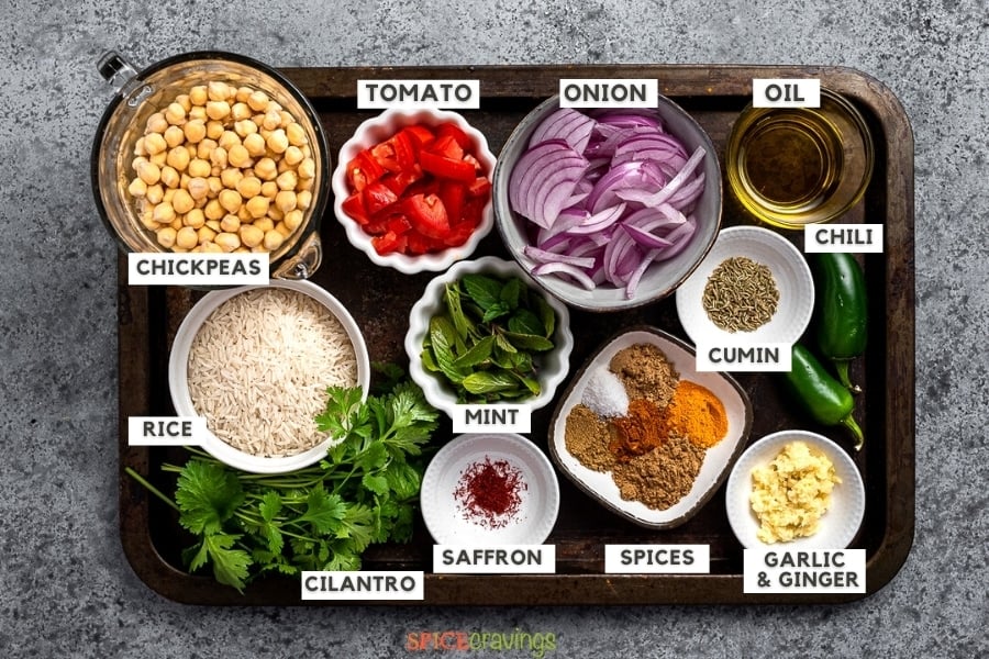 Ingredients for chana masala rice on metal tray