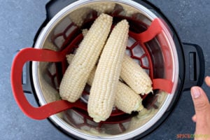 four corn cobs stacked in the instant pot