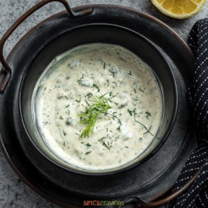 serving dish of lemon caper sauce with fresh dill