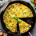 Scooping a slice of frittata from skillet