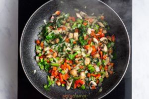 Sauteing chopped vegetables in skillet
