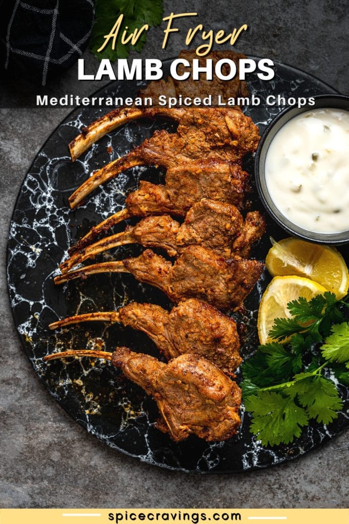 lamb chops on plate with tzatziki, parsley and lemon wedges