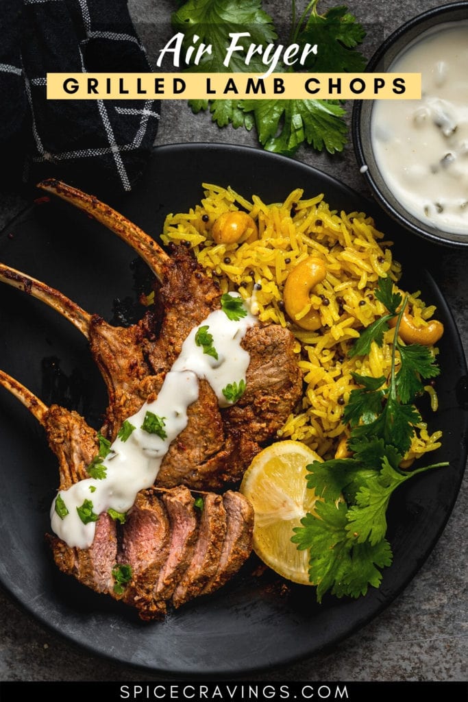 three lamb chops topped with tzatziki with saffron rice, lemon wedges on plate
