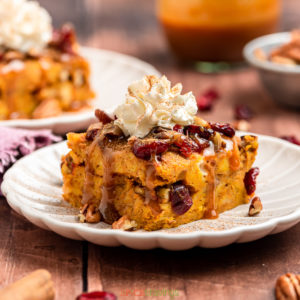 Slice of pumpkin spiced bread pudding with whipped cream