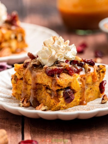 Slice of pumpkin spiced bread pudding with whipped cream