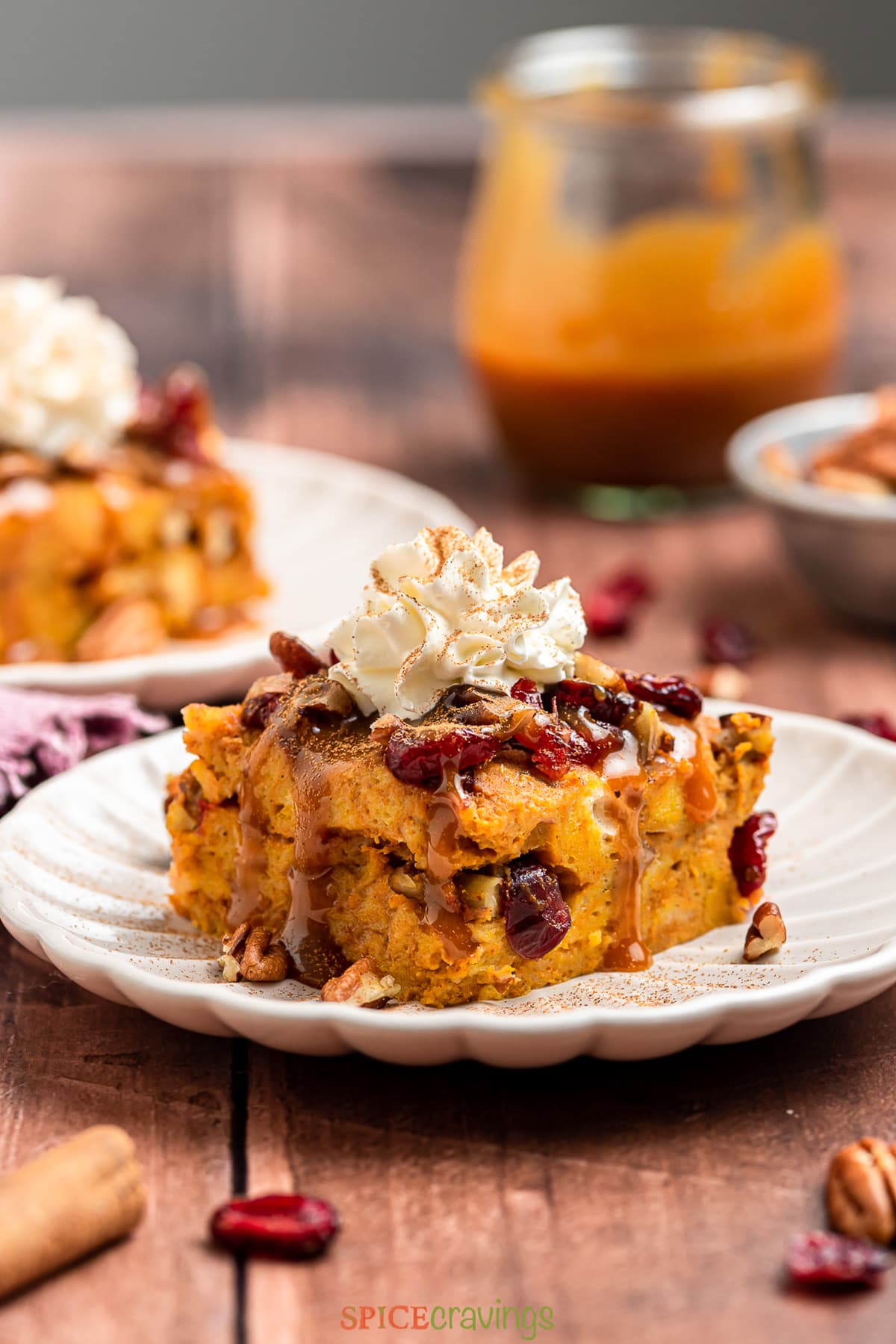 Bread pudding with pumpkin topped with whipped cream and cinnamon