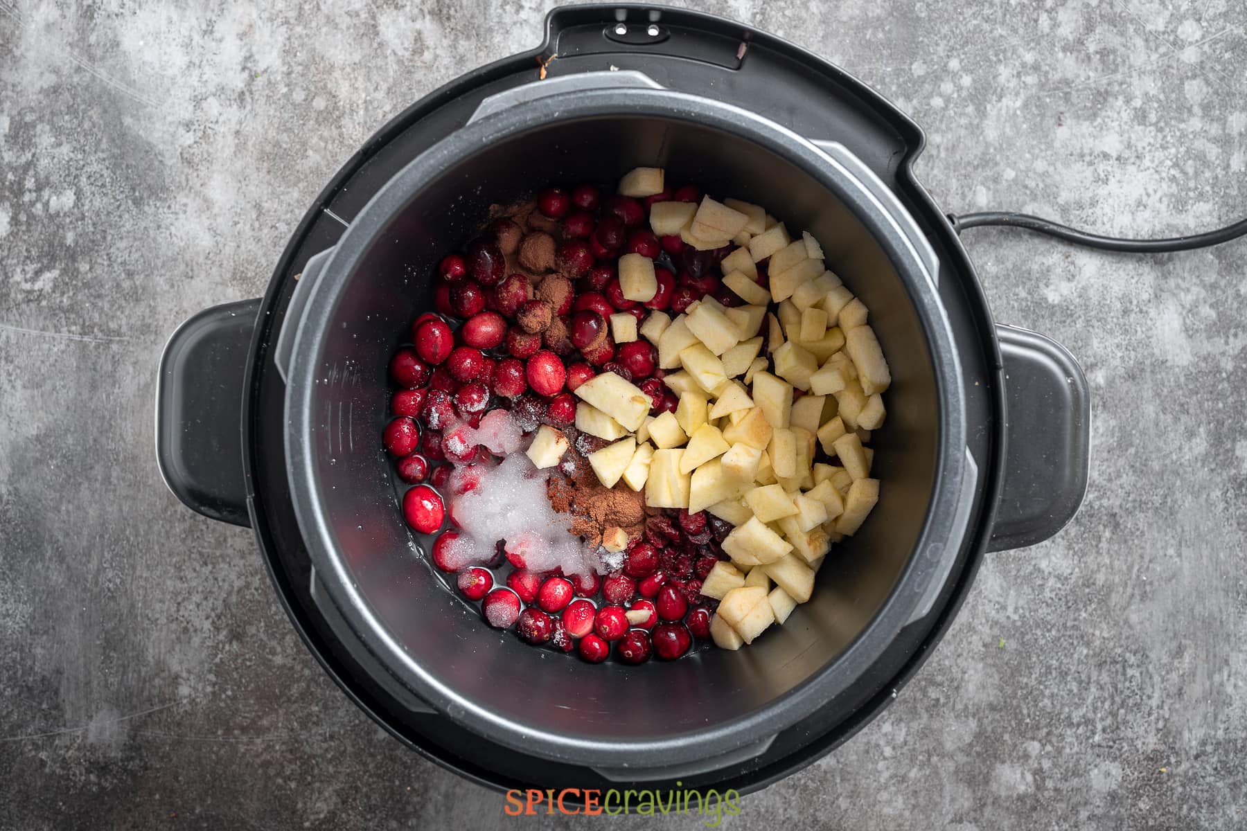 chopped apple, spices, sugar and cranberries added to the instant pot