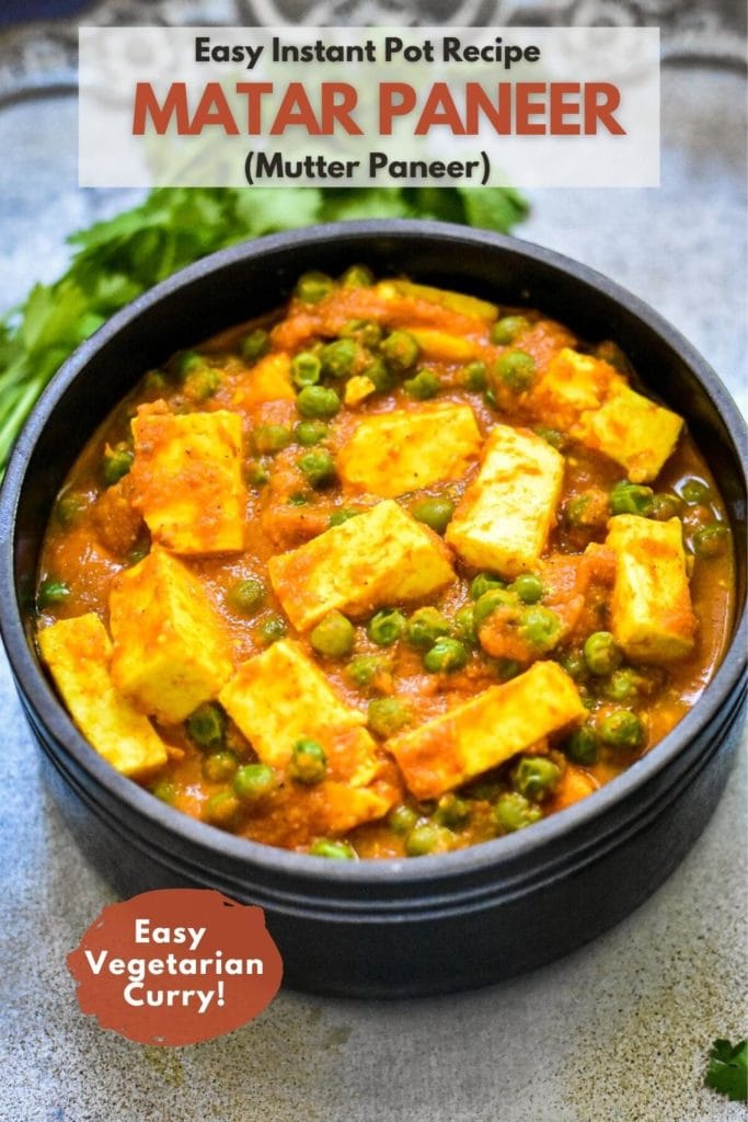 Indian paneer and peas curry, called Mutter Paneer, in black stone bowl