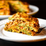 slice of spinach ravioli lasagna bake on white plate