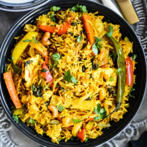 Indian style rice with vegetables in a blue bowl