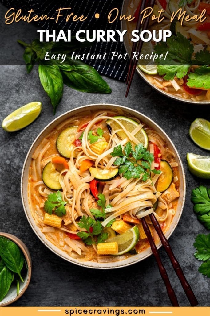 Thai red coconut curry soup with noodles, vegetables, garnished with cilantro and lime