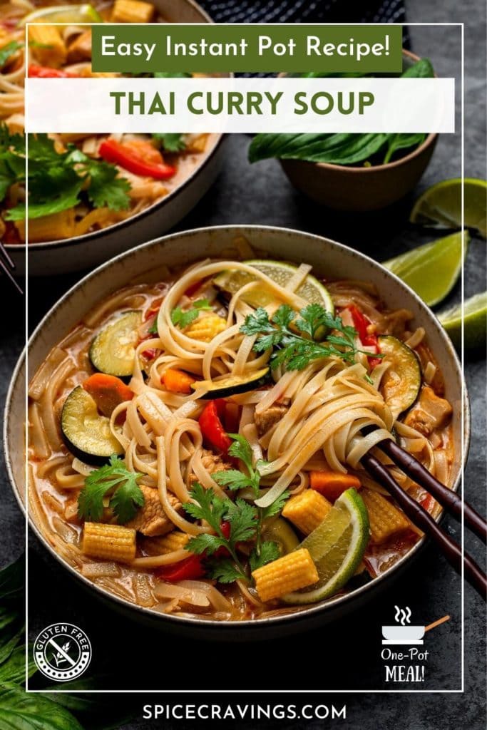 Bowl of curry soup with vegetables and noodles in chopsticks