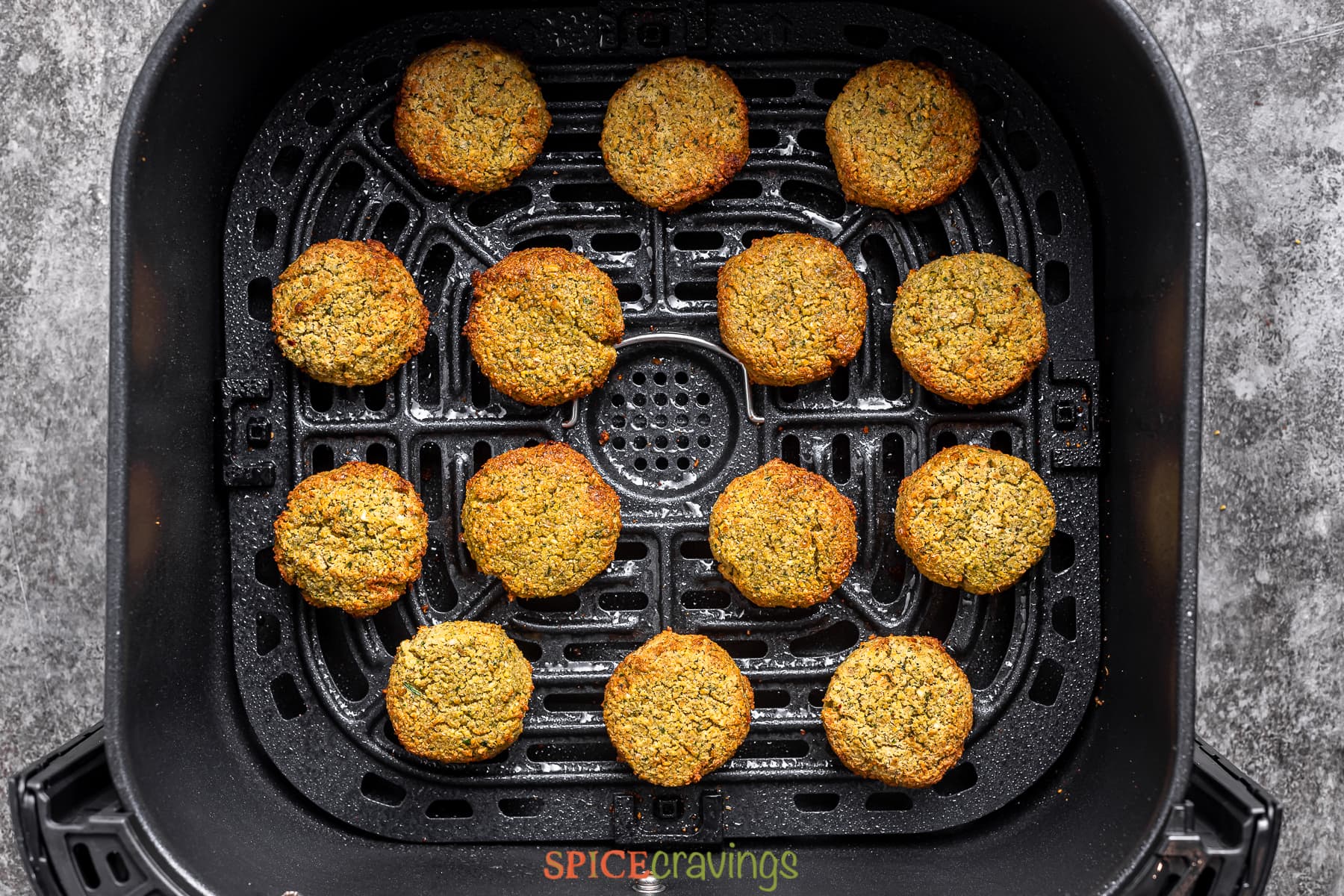 finished falafel patties in the air fryer basket