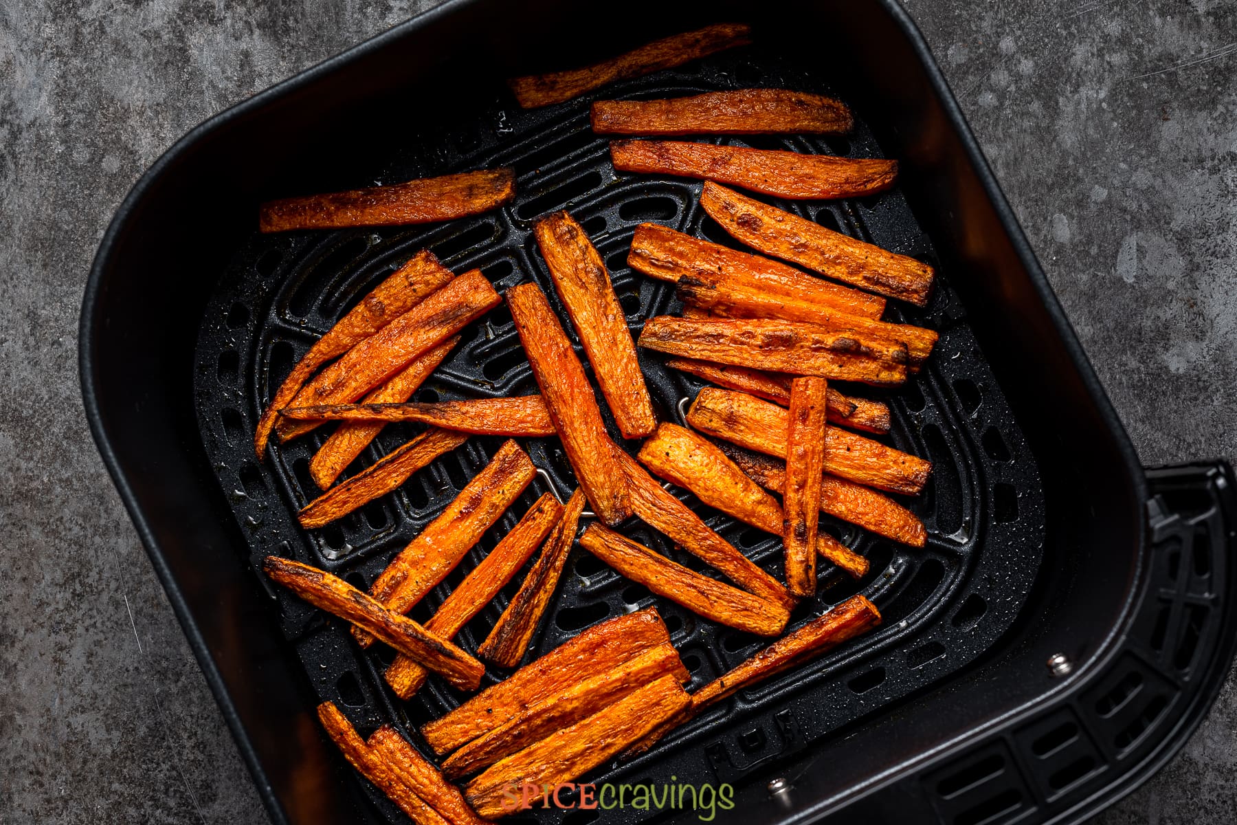 Air fried carrot fries in fryer basket