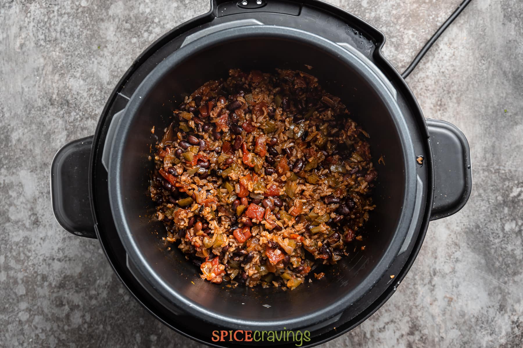 overhead of an instant pot with cooked rice and beans