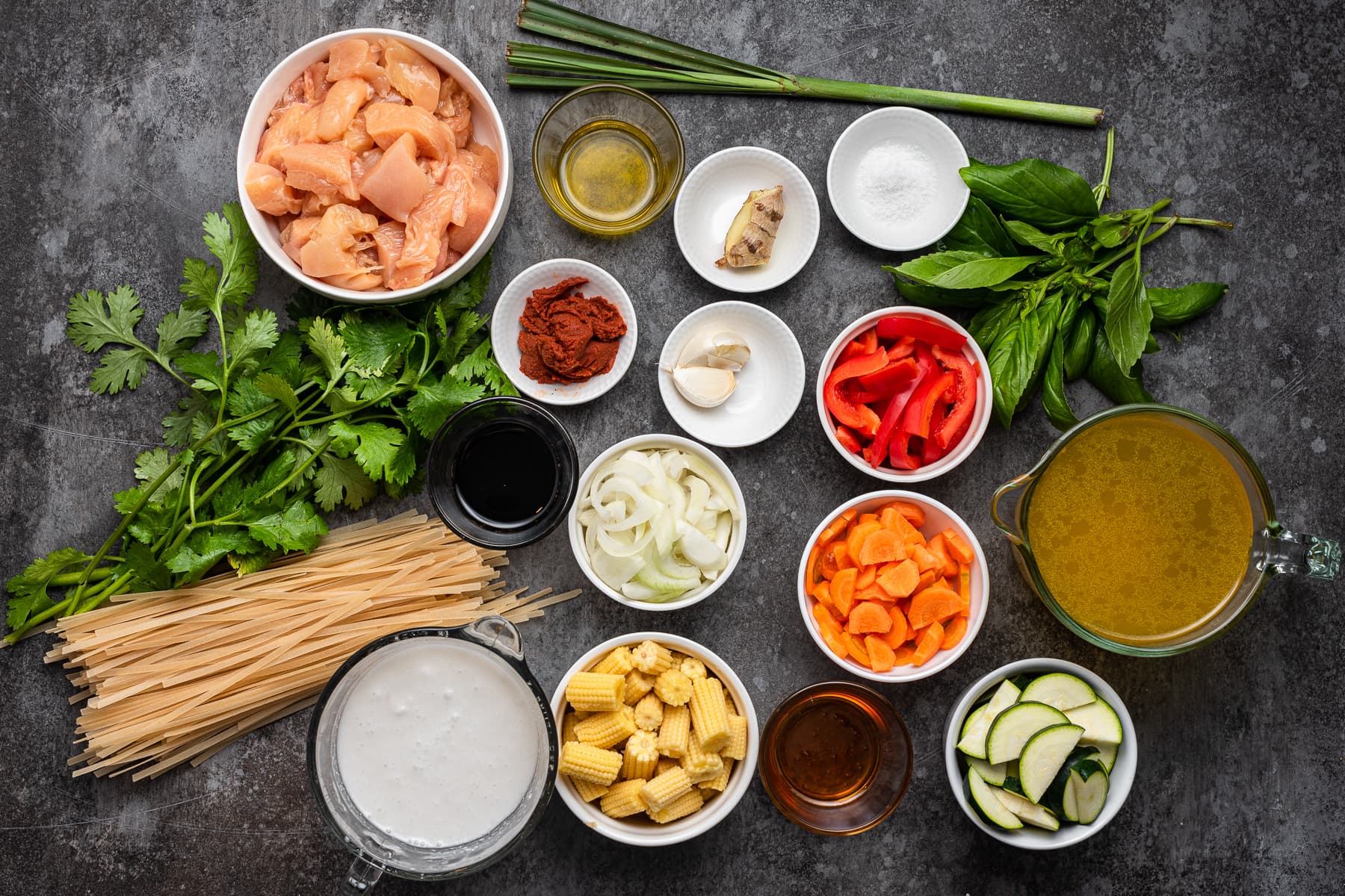 chicken, vegetables, stock, lemongrass, noodles among other ingredients for thai curry soup