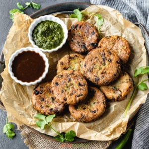plate of aloo tikki and chutney from above