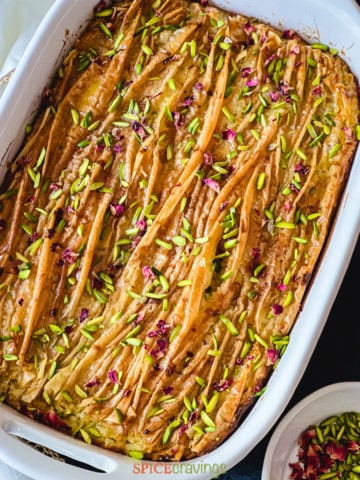 Baked Phyllo dough cake topped with nuts and dried rose