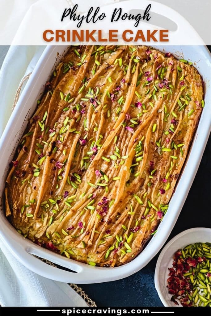 Baked phyllo dough cake in pan with pistachios and rose