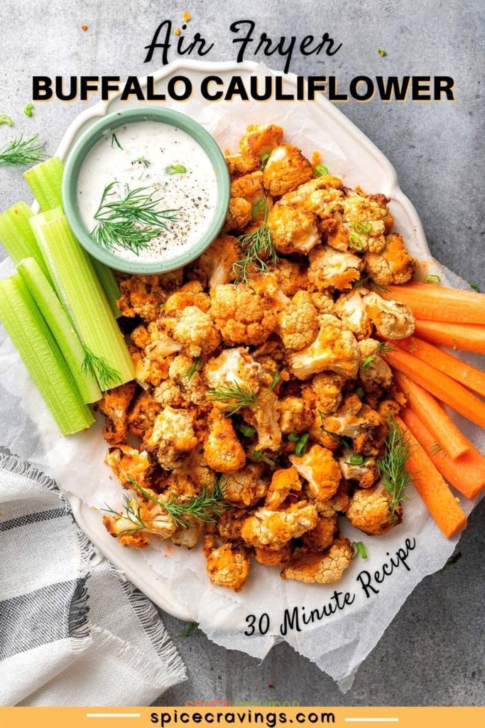 low carb air fryer cauliflower wings on white platter with celery, carrot sticks and creamy sauce