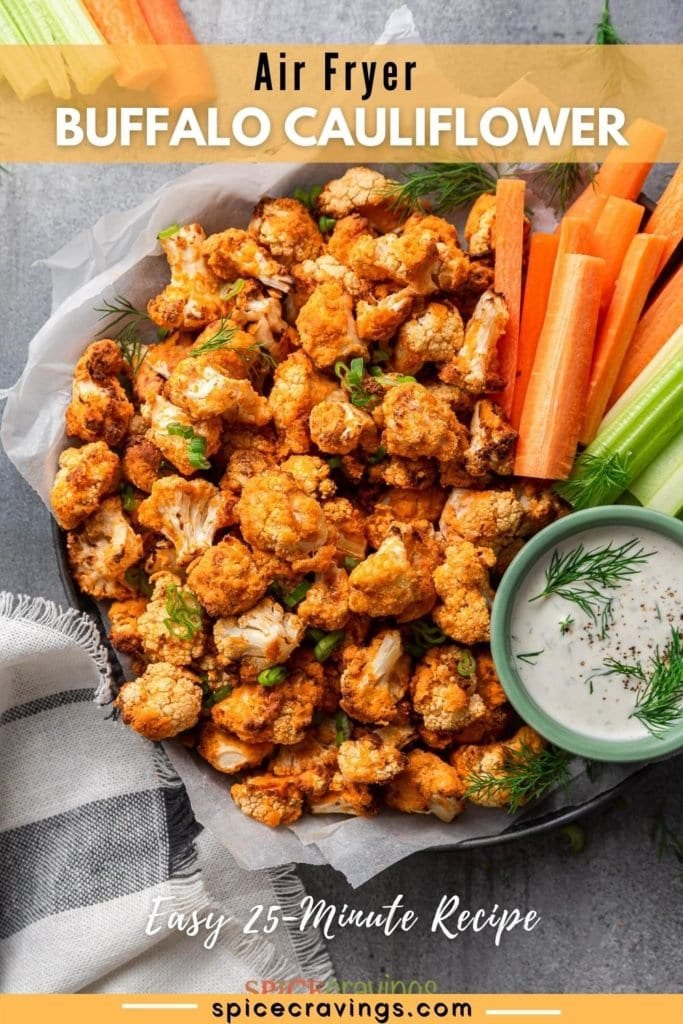 easy buffalo cauliflower wings on dark platter with celery, carrots and creamy dipping sauce