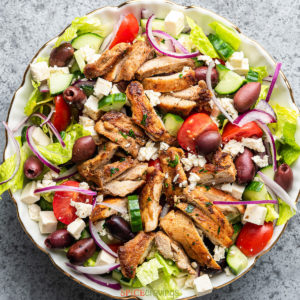 greek chicken salad recipe in large white bowl