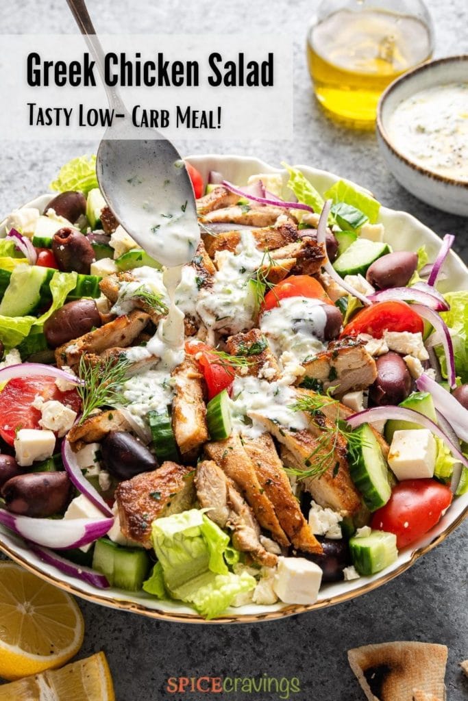 greek salad with chicken in large white bowl