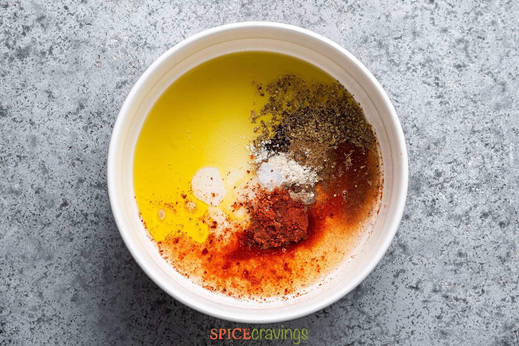 olive oil, Mediterranean ground spices, salt, pepper in white bowl