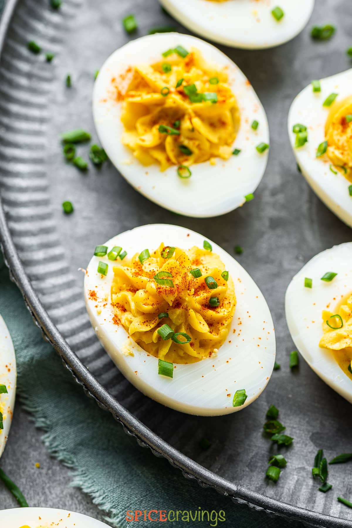 spicy deviled eggs arranged on gray plate