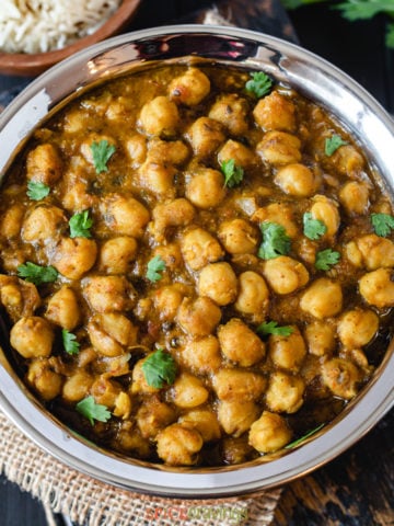 Indian chickpeas curry called chana masala in steel bowl
