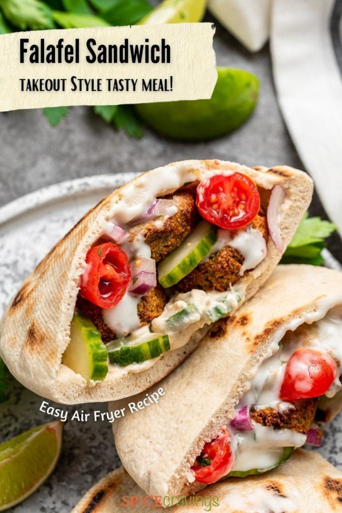 two falafel pita sandwiches on round plate with cucumbers and tomatoes