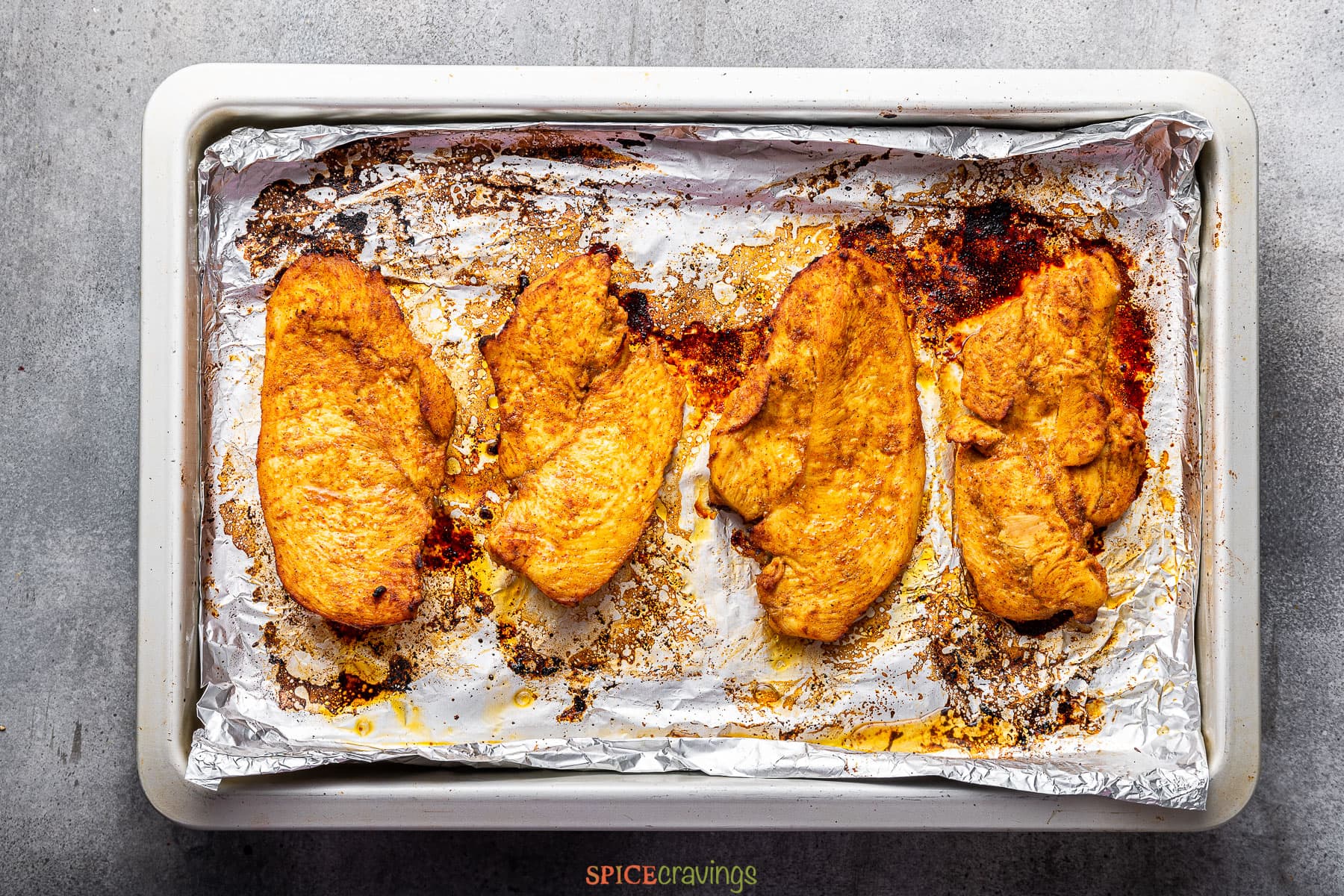 Mexican chicken on aluminum foil lined baking sheet