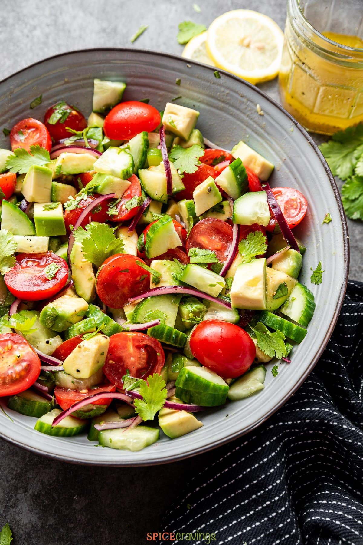 chopped cucumber, tomato, avocado salad in large bowl