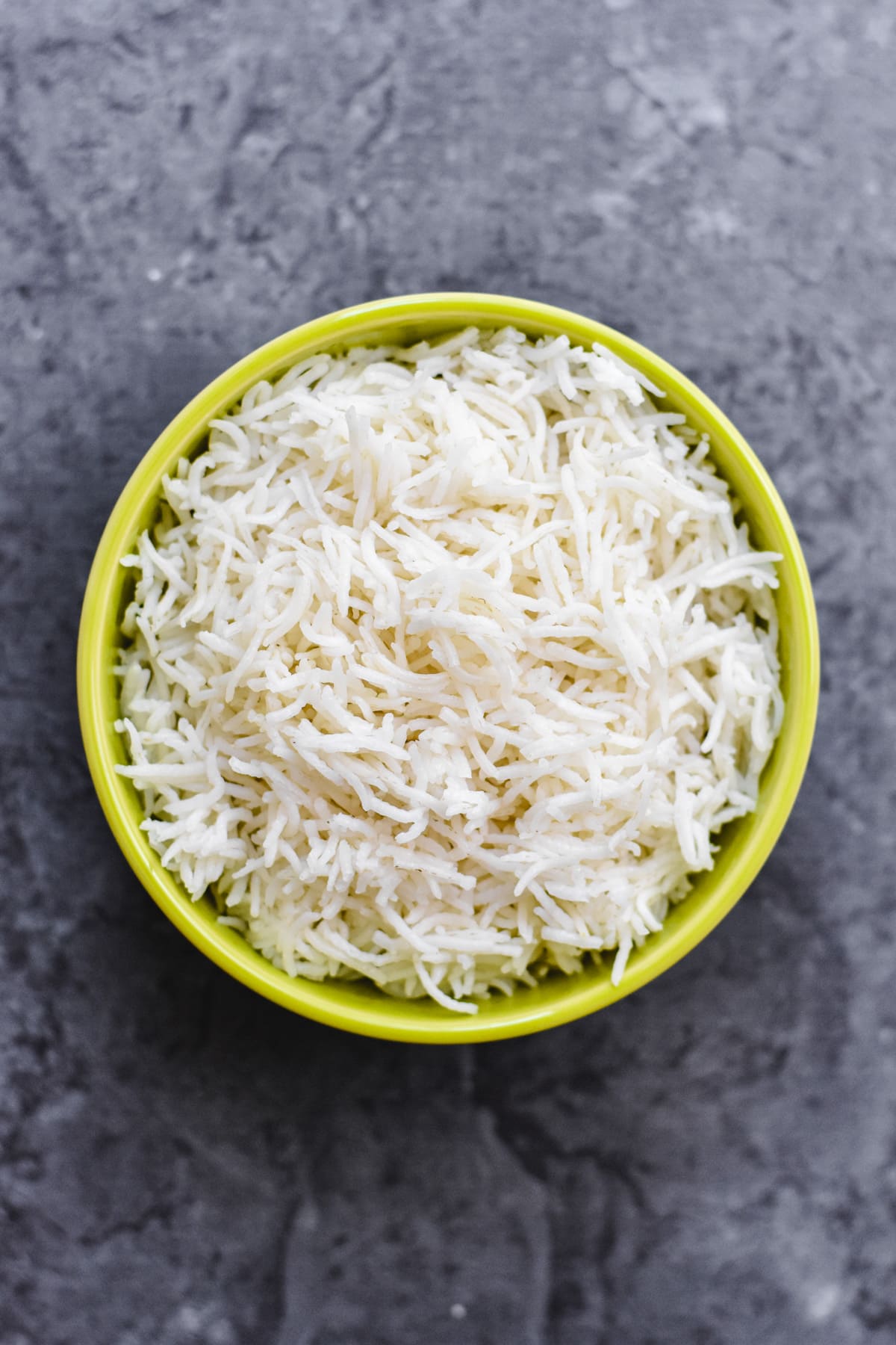 white basmati rice in neon green bowl
