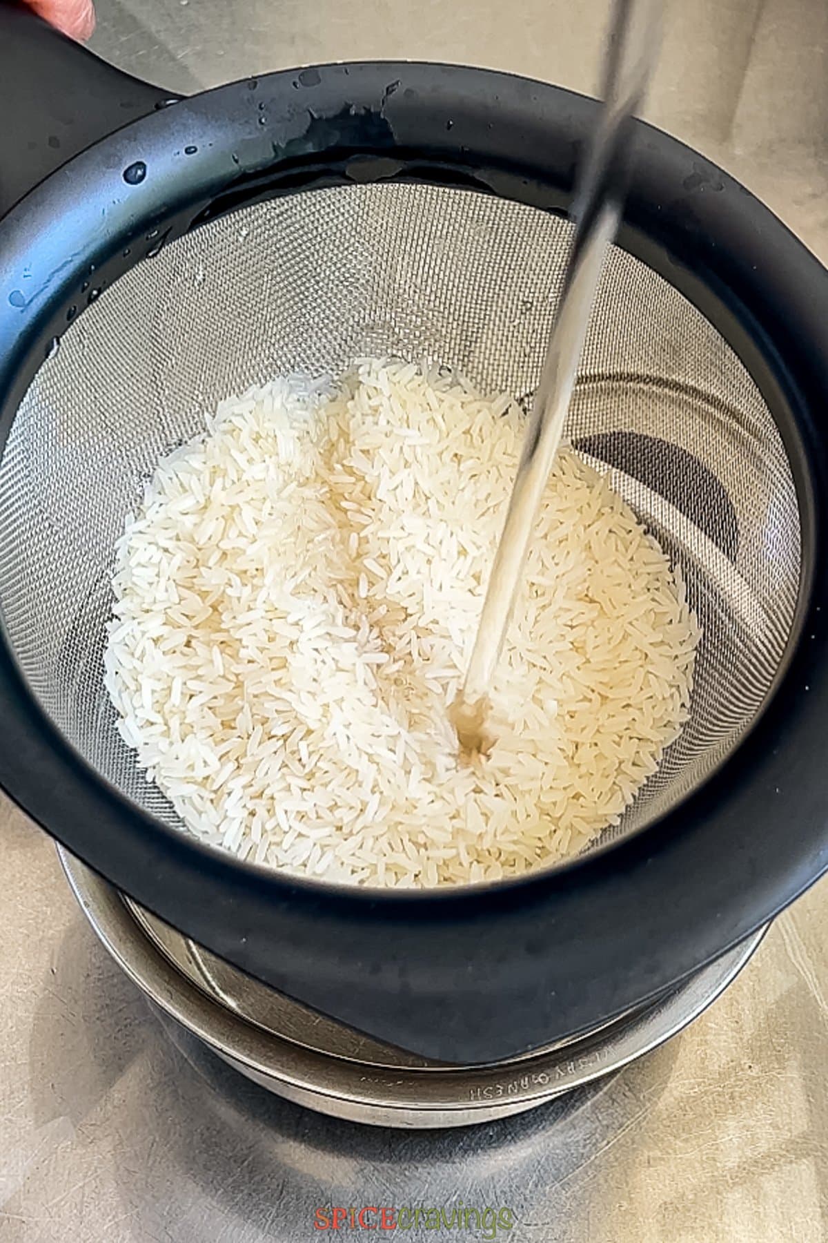 rinsing jasmine rice over running water